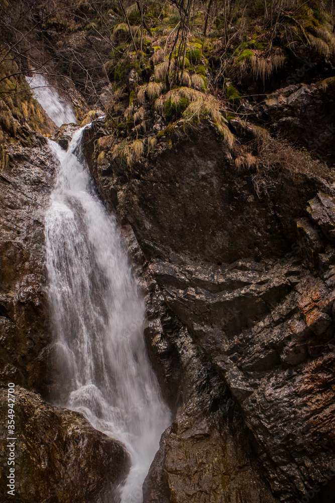 Fast flowing water over small rapids and waterfalls in Vintgar gorge, close to Borovnica, slovenia, on a dull winter day. Fast flowing water over small rapids and waterfalls in Vintgar gorge, close to Borovnica, slovenia, on a dull winter day.
