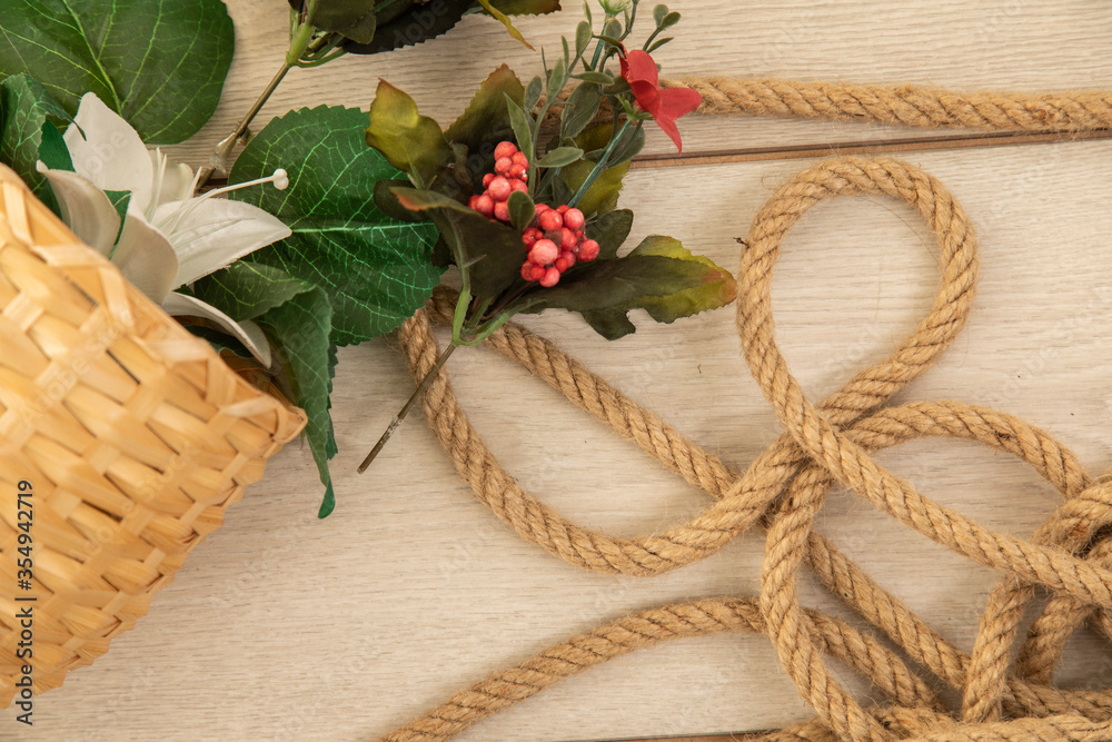 old rope and flower on the wooden background old rope and flower on the wooden background