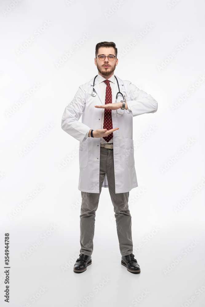 A portrait of a medical doctor posing against white background A portrait of a medical doctor posing against white background