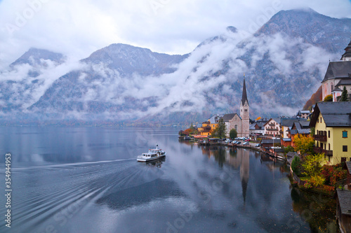 Hallstatt town view in a foggy day and clouds between the mountains, Austria.