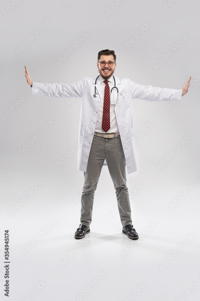 A portrait of a medical doctor posing against white background