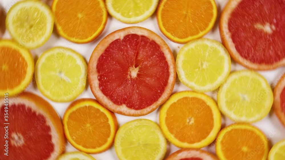 Slices of citrus fruits, lemon, orange, grapefruit rotating - Stop motion 