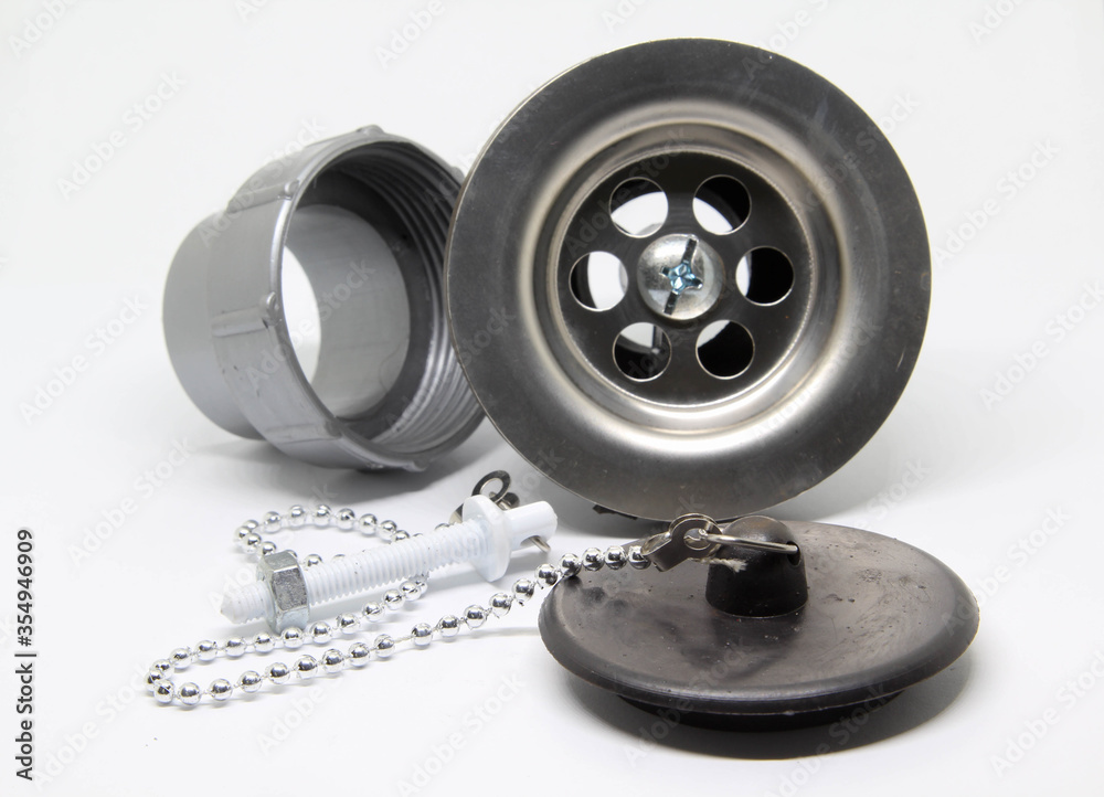 Naklejka premium Bath sink plughole set and rubber plug with chain on white background.