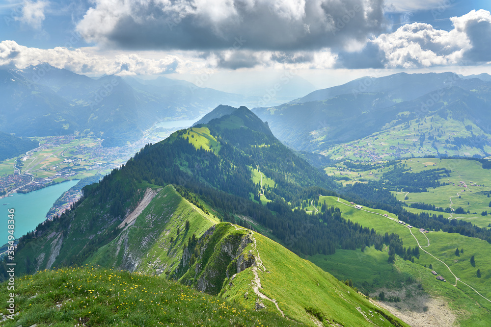 Landscape with Swiss Alps mountains and green nature. Photo taken at Hardergrat ridge trail / hike, near Interlaken, Switzerland. 
