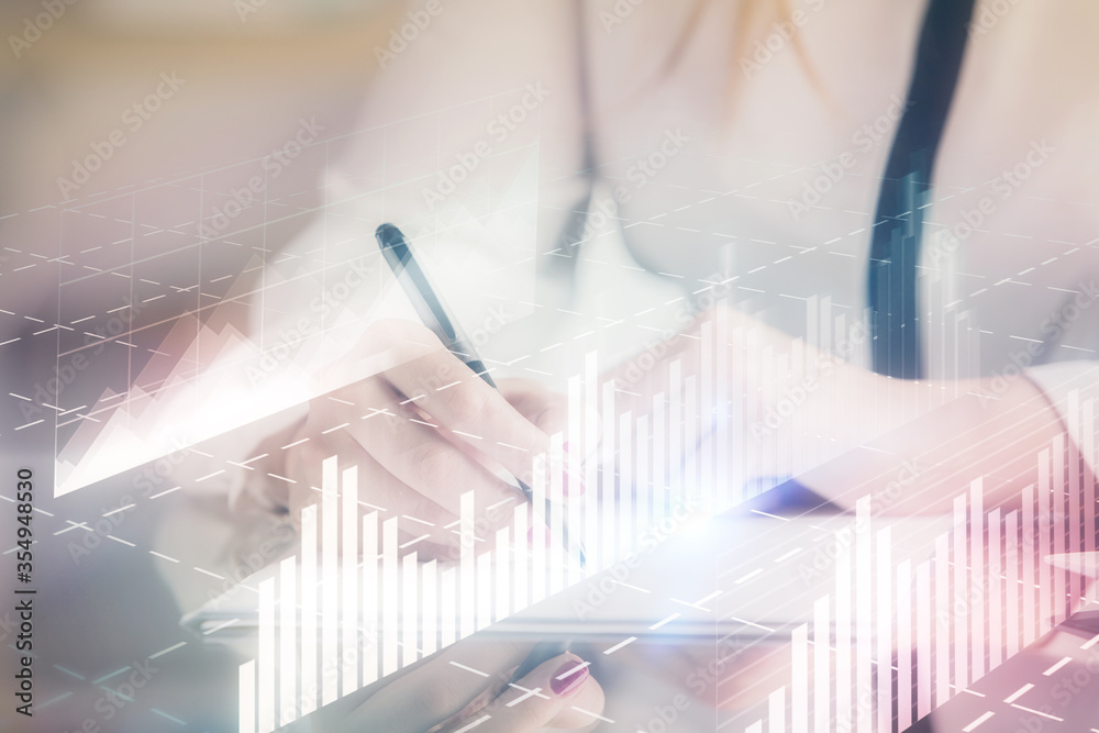 Double exposure of hands making notes with forex chart huds. Stock market concept. Double exposure of hands making notes with forex chart huds. Stock market concept.