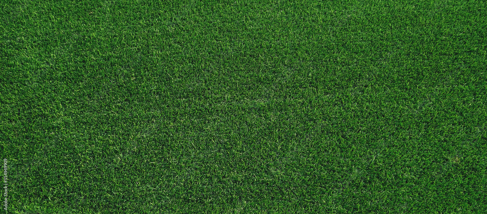 texture of artificial green grass. top view panorama background.