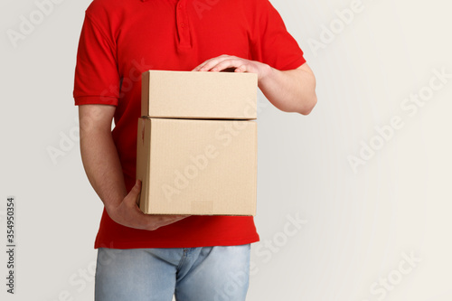 Protection of customer goods. Deliveryman carefully holds cardboard boxes