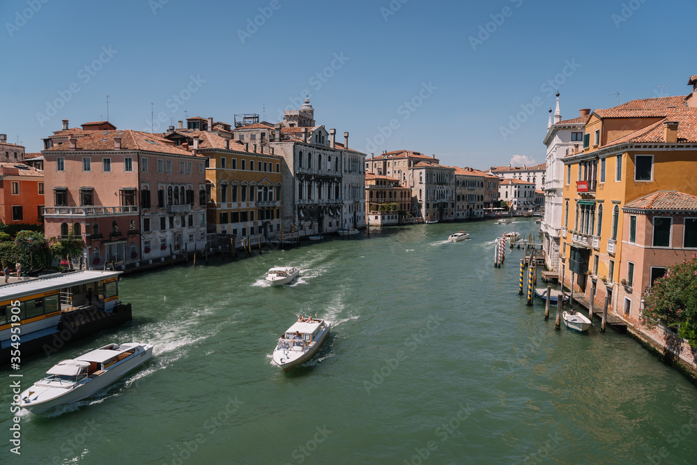 Boats goes along the Grand Canal in Venice, Italy.