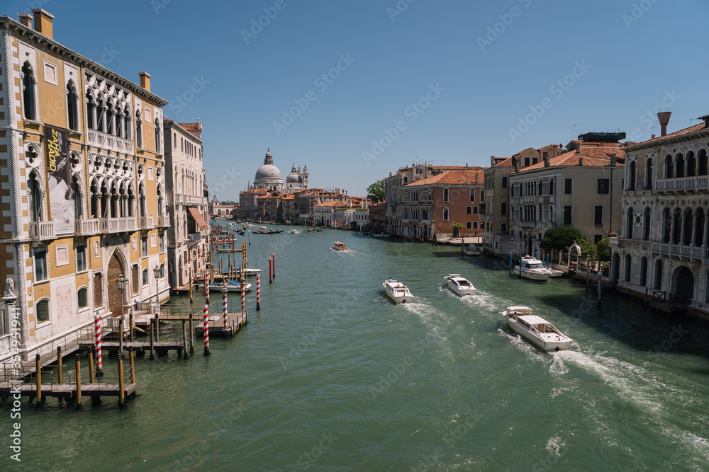 Boats goes along the Grand Canal towards San Simeone Piccolo church in Venice, Italy.