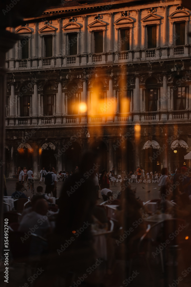 View through the window to the restaurant of Venice and the people reflected in the window from the street, Italy.