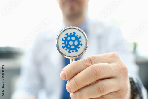 Doctor holds stethoscope infected with coronovirus