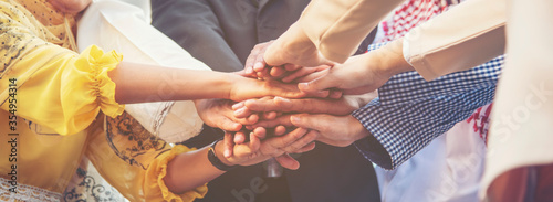 Group of people diversity multiethnic teamwork collaboration team meeting communication  Unified team concept. Business people hands together diversity multiethnic diverse culture partner team meeting photo