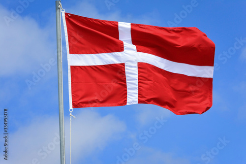 Denmark flag in the wind on the top of the mast
