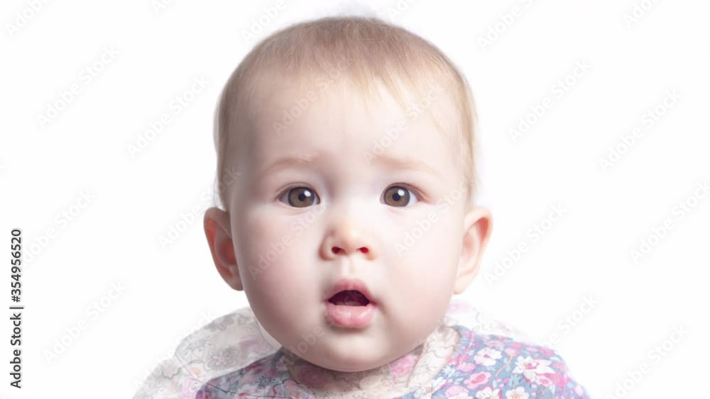 Face transformation of the little girl. Face of the infant baby seven monthes old smoothly transforms into the face of the same baby of one year old Face transformation of the little girl. Face of the infant baby seven monthes old smoothly transforms into the face of the same baby of one year old