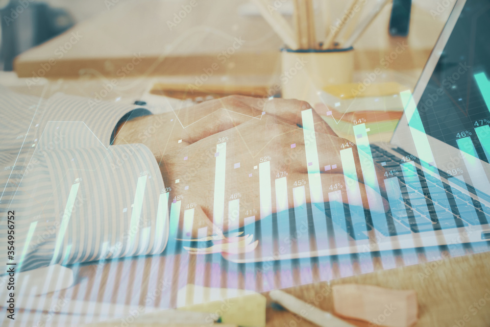 Multi exposure of stock market graph with man working on laptop on background. Concept of financial analysis. Multi exposure of stock market graph with man working on laptop on background. Concept of financial analysis.