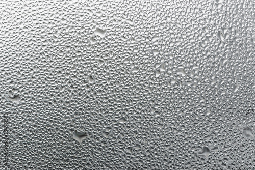 Macro photography of water drops on glass window white background after the rain