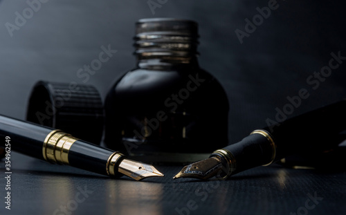 Fotografie Beautiful fountain pen. under exposed photo on a black background