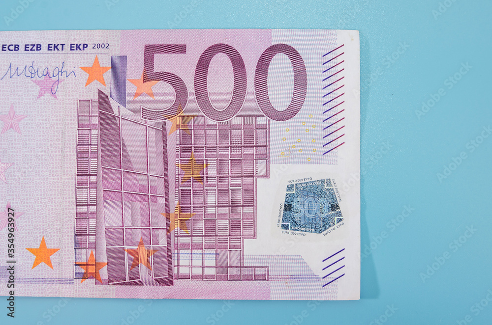 500 Euro banknote isolated on a blue background. Close-up. 500 Euro banknote isolated on a blue background. Close-up.