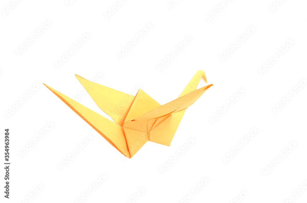 Naklejka premium A yellow origami bird flying over white