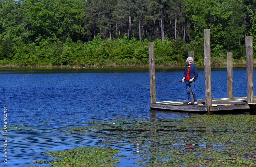 Elderly Fisherwoman Enjoys a Day on the Lake