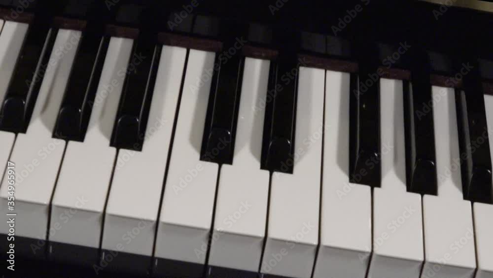 Close up pan of keys on a piano. Close up pan of keys on a piano.