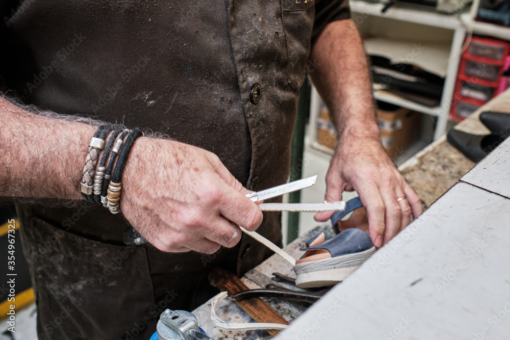 shoemaker man working in his shoe shop shoemaker man working in his shoe shop