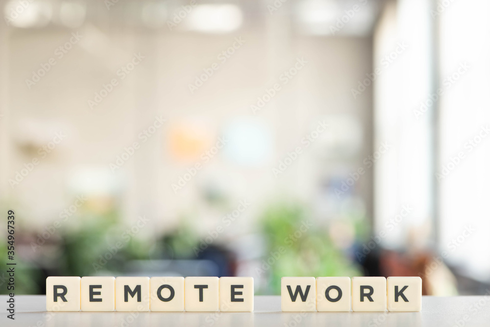 white cubes with remote work lettering on white desk in office