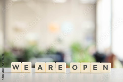 white cubes with we are open lettering on white desk in office