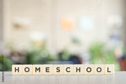 white blocks with homeschool lettering on white desk photo