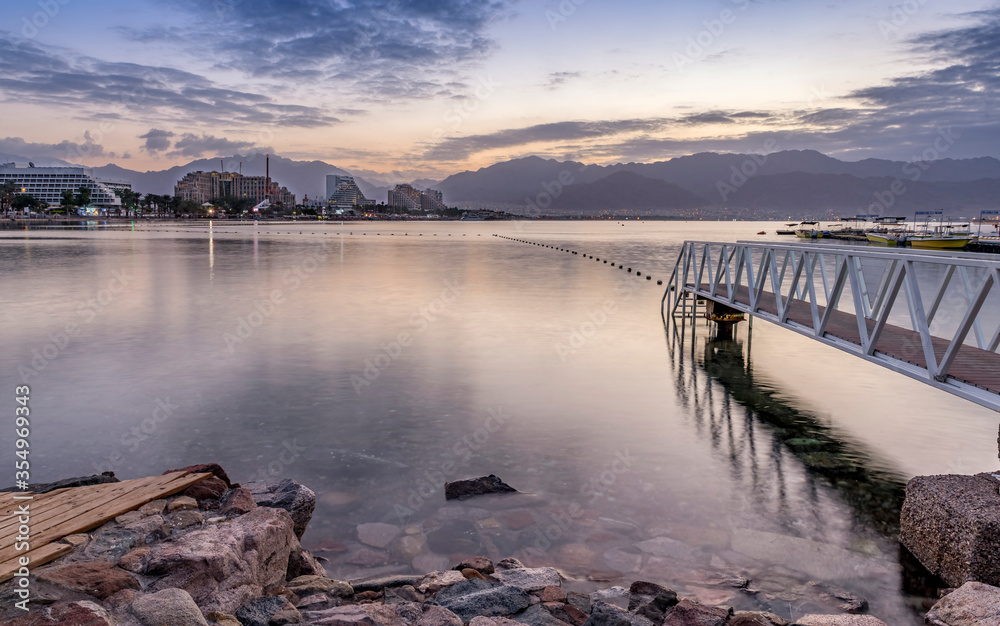 Morning scene at the Red Sea seen, central beach of Eilat - famous tourist resort and recreational city of Israel