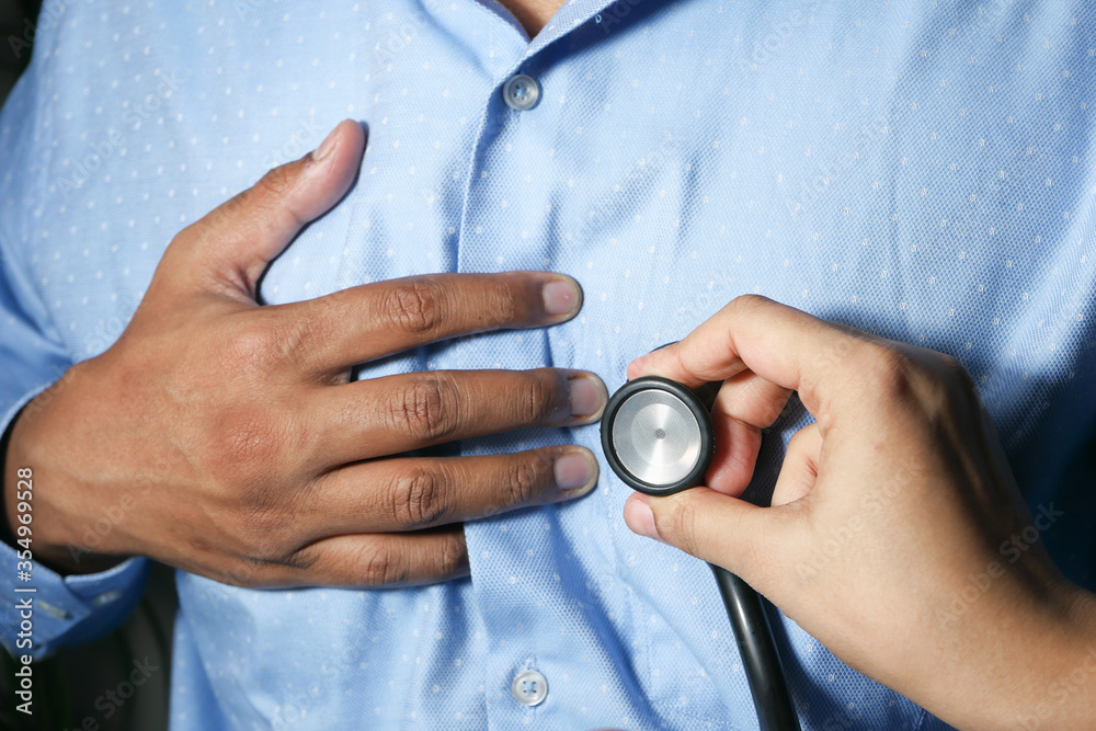 Fototapeta premium Doctor using a stethoscope checking body, close up