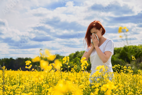 Konstfotografi Allergic to pollen and flowering season, a girl sneezes in a flower field