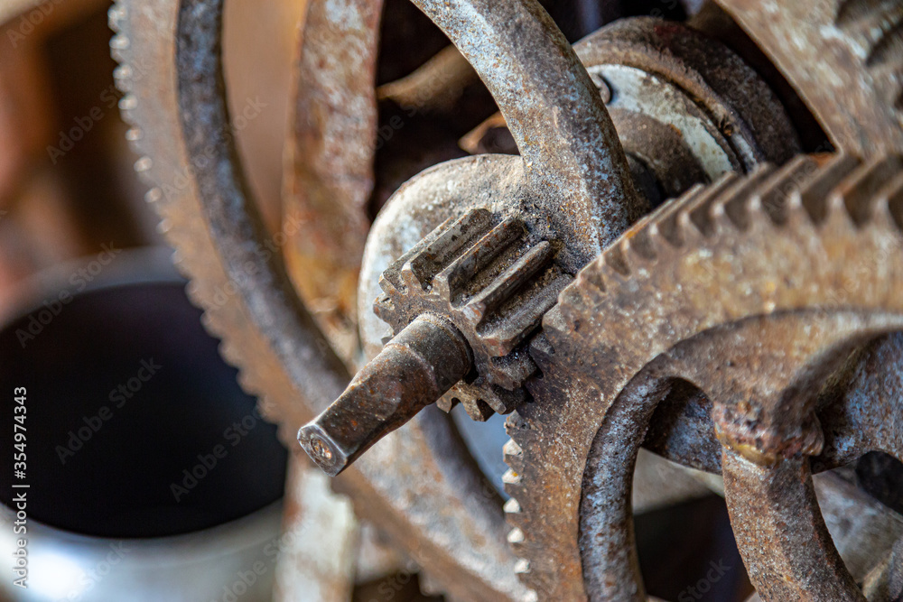 Gears in an old and rusty gear reductor trasmission with soft focus. Gears in an old and rusty gear reductor trasmission with soft focus.