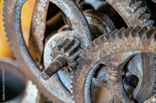 Gears in an old and rusty gear reductor trasmission with soft focus.