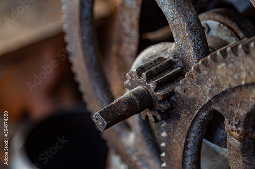 Gears in an old and rusty gear reductor trasmission with soft focus. photo