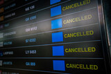 flights cancellation status on flights information board in airport because coronavirus or pandemic effected. flight cancellation, airline business crisis, airline bankrupt, tourism crisis concept