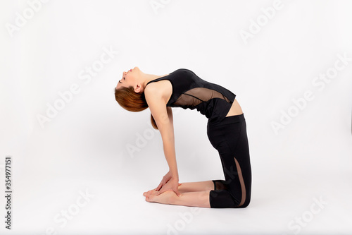 girl doing sports stretching on a white background, tilt back, space for text