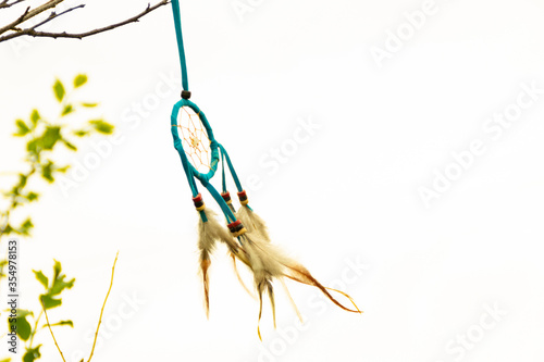 Dream catcher close-up on a white sky background. Blurred background.