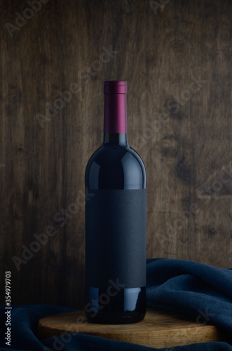 red wine bottle on wooden background