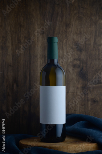 white wine bottle on wooden background