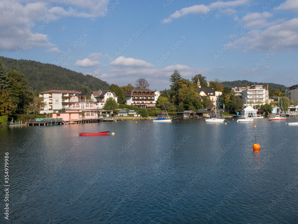 Hotels and other buildings lining the shore of beautiful blue Wörthersee in Austria