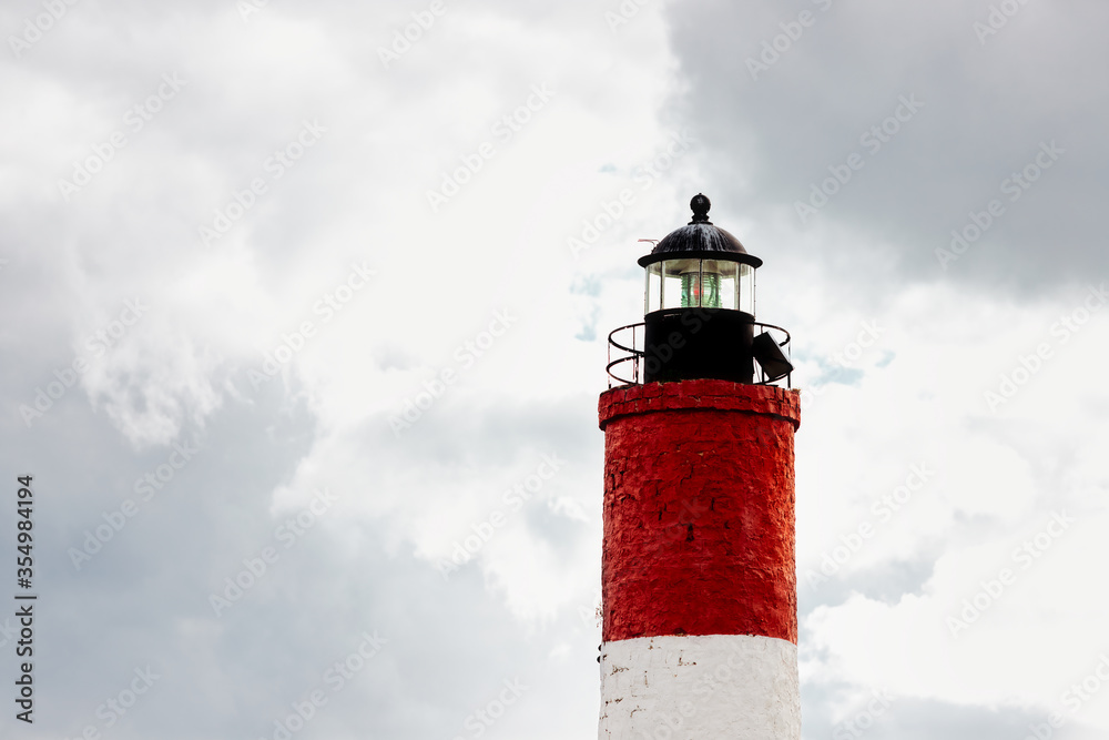 Close-up of the top of the Les Eclaireurs lighthouse near Ushuaia (Argentina) against cloudy sky