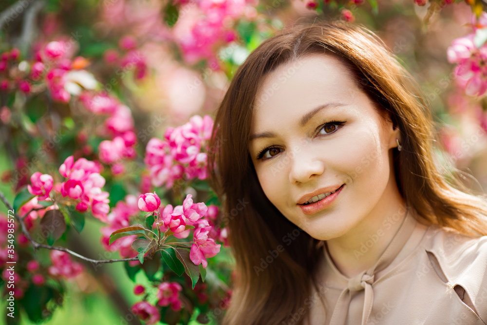 portrait of a beautiful young woman with make-up near a tree with flowers portrait of a beautiful young woman with make-up near a tree with flowers