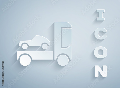 Paper cut Car transporter truck for transportation of car icon isolated on grey background. Paper art style. Vector Illustration