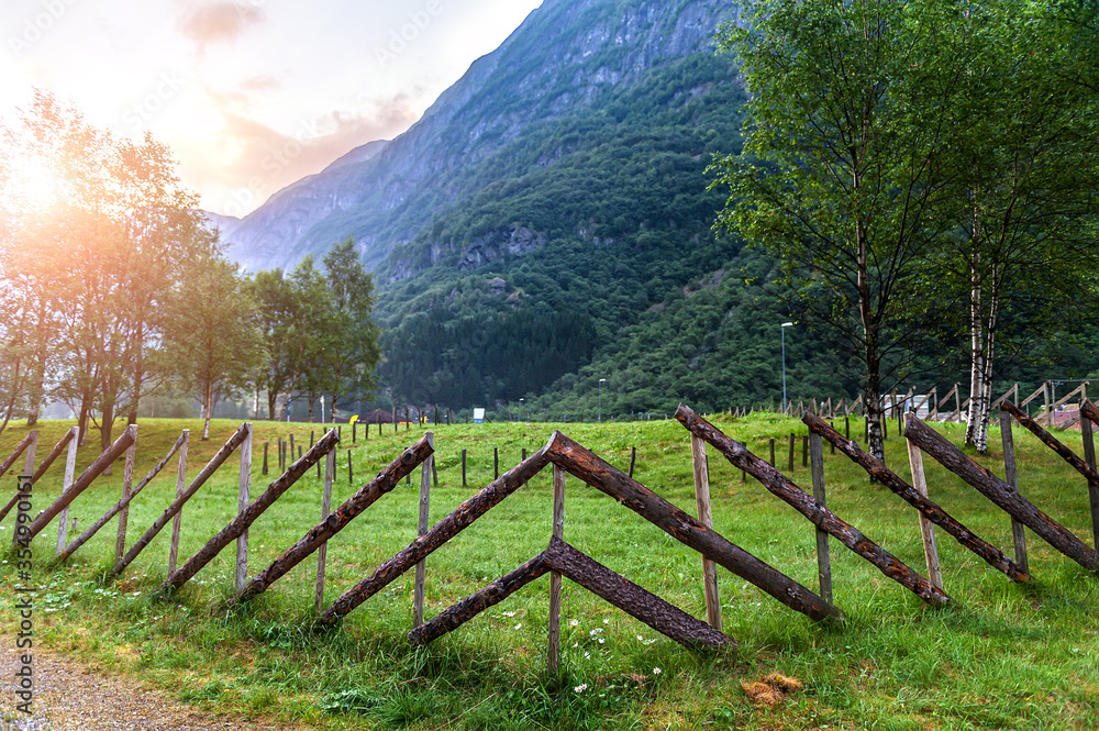 A stylized fence of the ancient Vikings. Beautiful idyllic mountain landscape. Gudvangen is a popular tourist village located at the very beginning of the Neroifjord