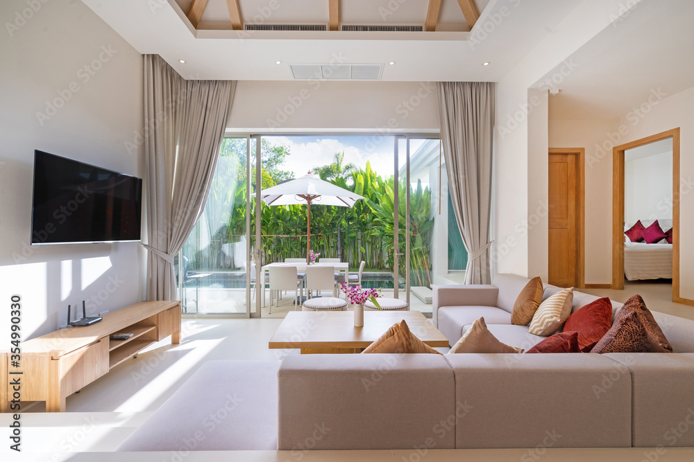 Interior and exterior design of living room with pool view in luxury ...