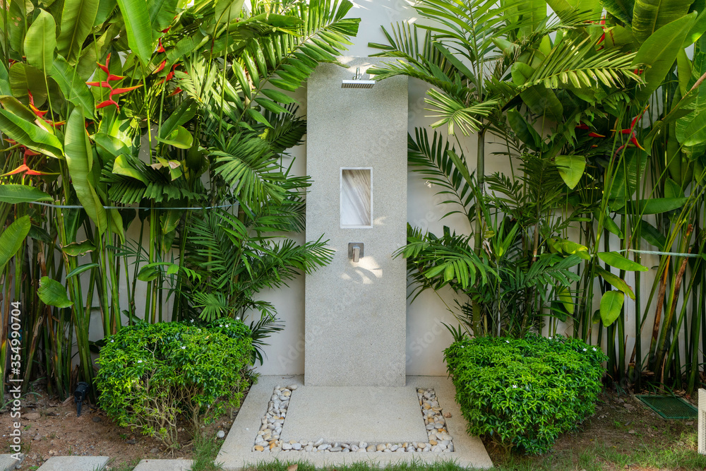 Exterior design of outdoor shower in garden of luxury pool villa, house,  home feature rain shower head and garden landscape foto de Stock | Adobe  Stock