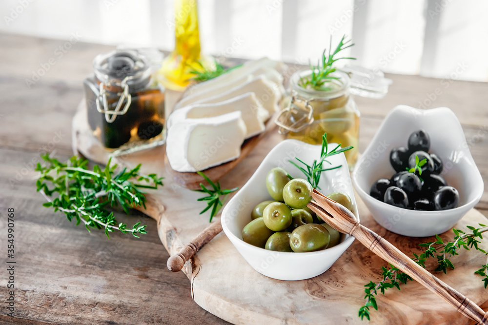 Olives are green and black with soft cheese with mold like brie, Camembert with olive oil and thyme