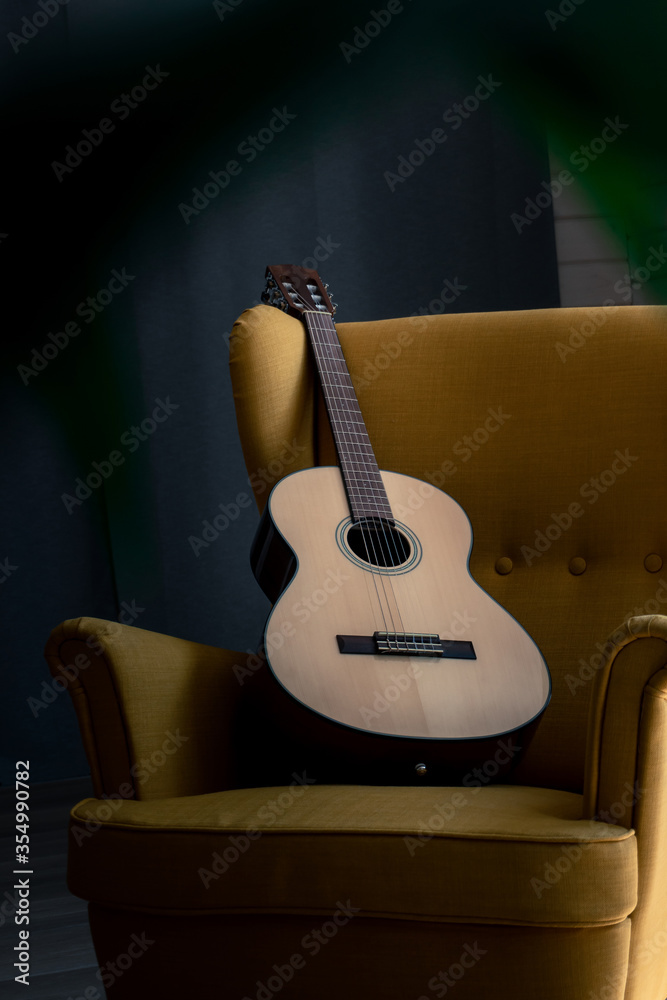 Fototapeta Acoustic guitar on the armchair
