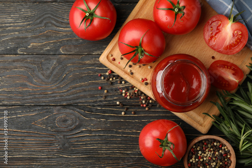 Composition with tomatoes and sauce on wooden background. Ripe vegetable